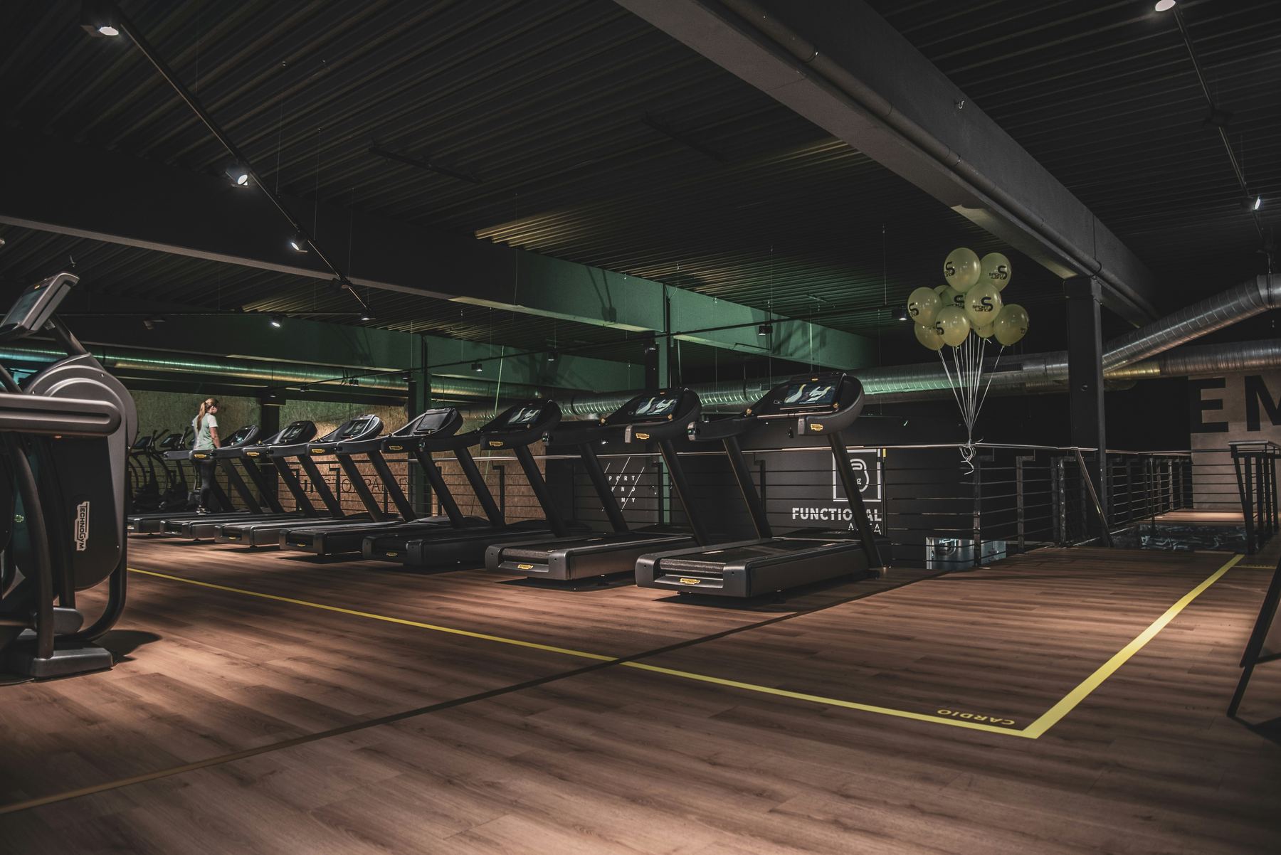 Clean modern gym floor and equipment ready for members