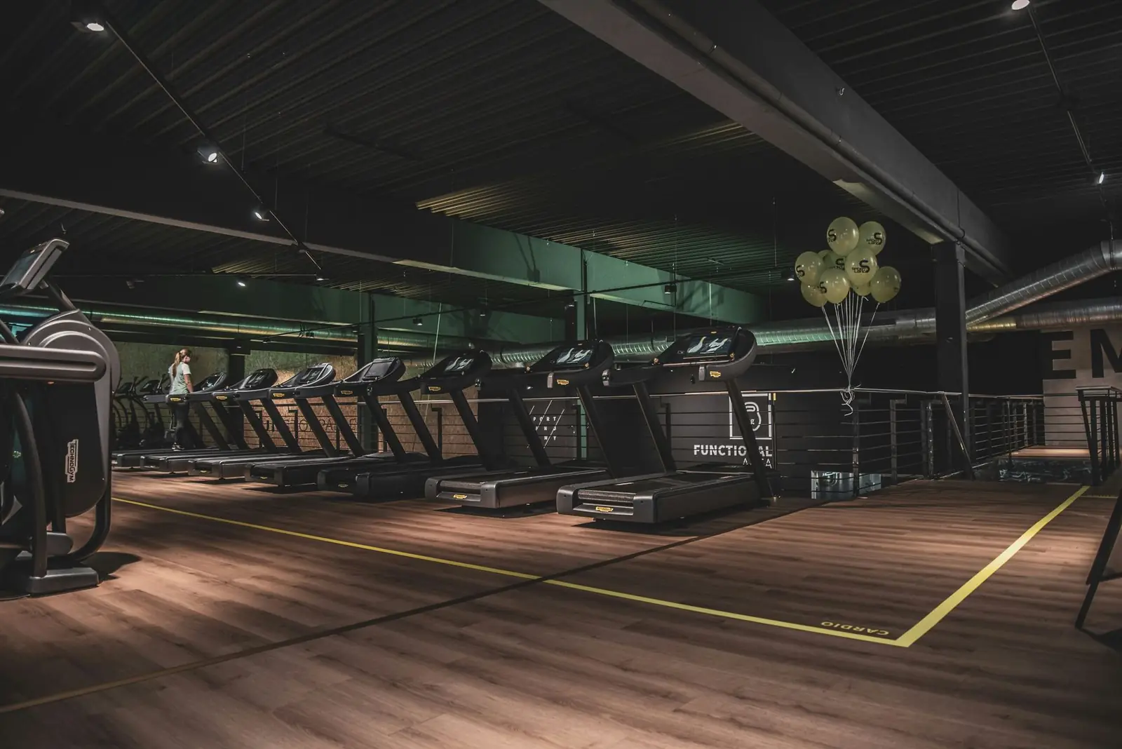 Clean modern gym floor and equipment ready for members